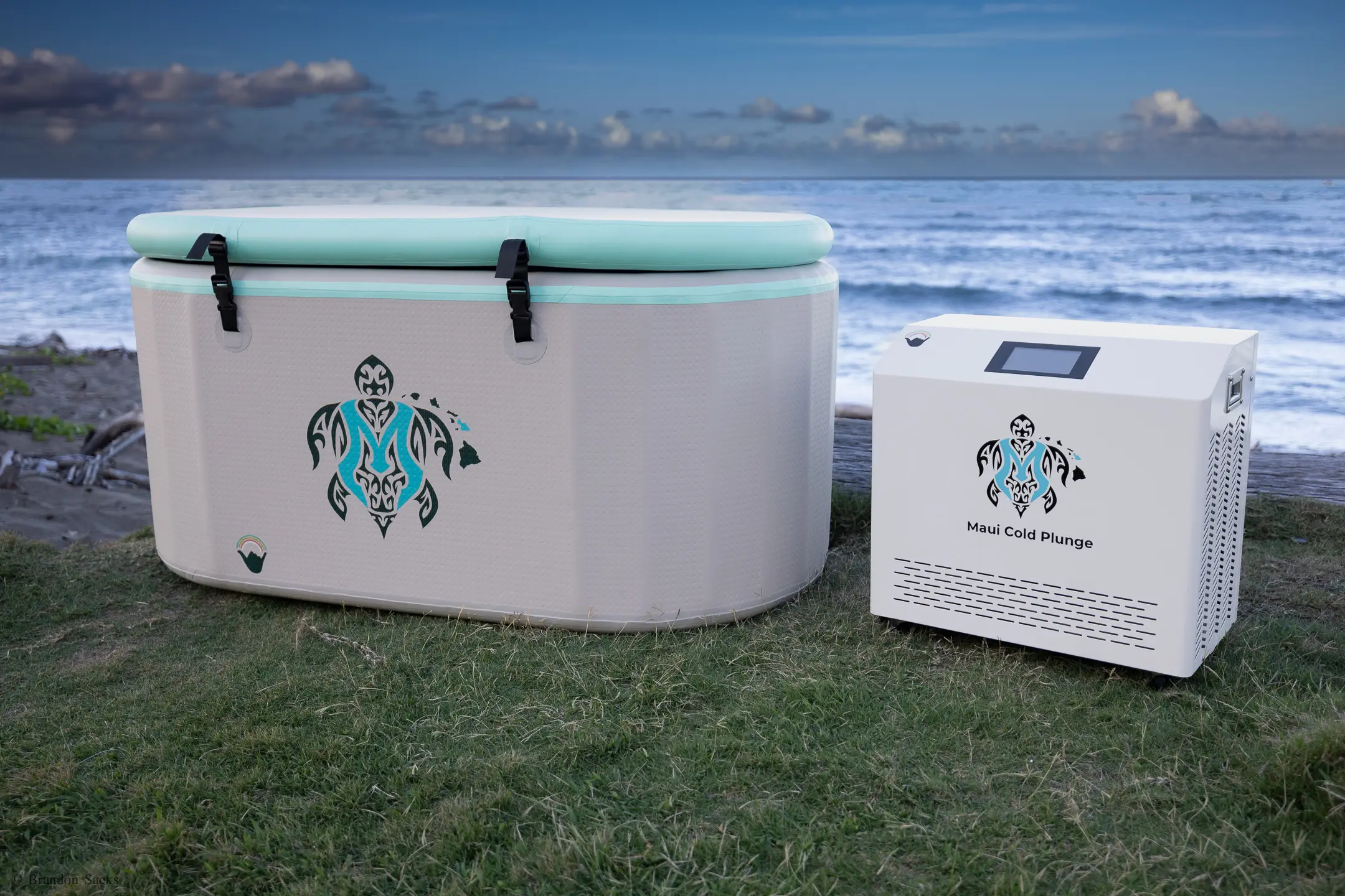 A cooler and an air conditioner sitting on the grass.