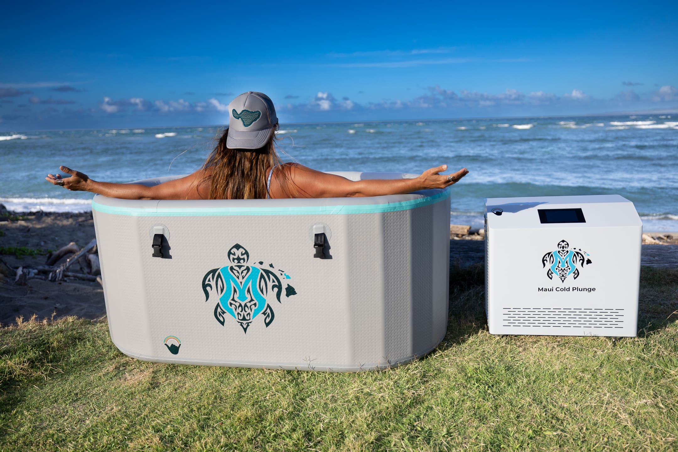 A woman sitting in an inflatable hot tub.